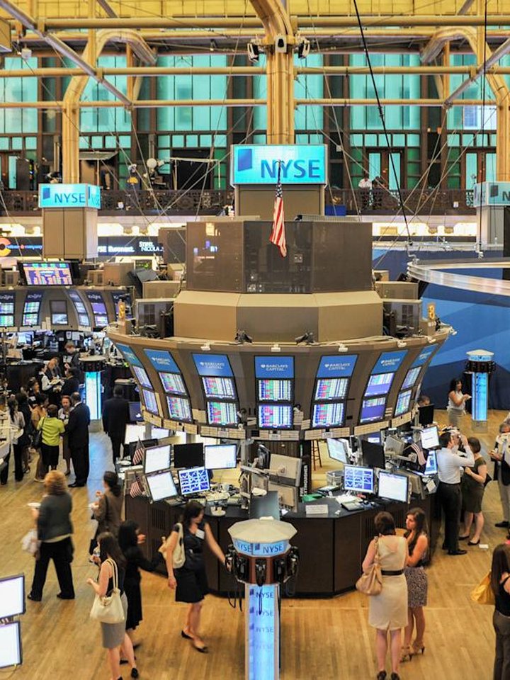 Traders and screens on a stock exchange floor
